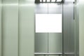 Mock up. Vertical poster media template frame hanging on the wall inside elevator lift Royalty Free Stock Photo