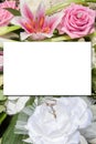 Mock-up wedding pastel pink flower rose bouquet and bride groom rings with white sheet paper empty space for marriage text mock up Royalty Free Stock Photo