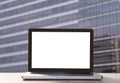 Mock up white blank laptop computer screen on desk in office background, empty blank display on table at workplace, business devic Royalty Free Stock Photo