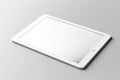 Mock up. White digital tablet computer with blank black screen mockup lies on the light gray surface background Royalty Free Stock Photo