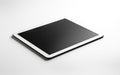 Mock up. White digital tablet computer with blank black screen mockup lies on the white surface background. Ai Royalty Free Stock Photo