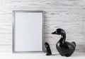 Mock up white frame and ceramic swans decoration with copy space for text
