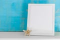 Mock up with white frame and star fish with a turquoise rustic ba Royalty Free Stock Photo