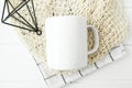 Mock-up of a white mug with kitchen towel and beige net bag Royalty Free Stock Photo