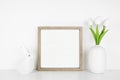 Mock up wood frame with Easter decor on a white shelf