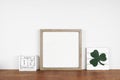 Mock up wood frame with St Patricks Day decor on a wood shelf Royalty Free Stock Photo