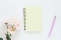 mock up yellow notebook on a spring, gently pink chrysanthemums and a lilac pen on a white background. Royalty Free Stock Photo