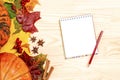 Mockup Autumn composition. Paper blank and pencil, pumpkins and leaves on wooden background. Autumn, thanksgiving concept. Flat