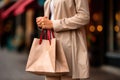 Mockup of a beige bag for applying a logo in the hands of a woman