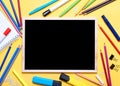 Mockup of Black board, pencils, highlighters, chalks on yellow background Royalty Free Stock Photo