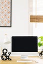 Mockup of black computer monitor on wooden desk in work area int Royalty Free Stock Photo