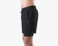 Mockup of black men`s loose shorts with compression lining, training undershorts on a man`s athletic body, isolated on backgroun