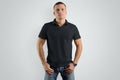 Mockup black polo shirts. Athletic man is isolated on a gray b Royalty Free Stock Photo