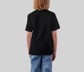 Mockup of a black t-shirt for a girl, back view, fashionable children\'s streetwear for design, print, pattern