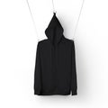 Mockup of black textured sweatshirt with zipper, pocket, pullover hanging on ropes, hoodie isolated on background