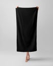 Mockup of a black towel, a girl holds a full-length bath towelette, isolated on a white background in the studio Royalty Free Stock Photo