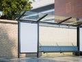 Mockup of blank banner on a bus stop in modern city. 3d rendering Royalty Free Stock Photo