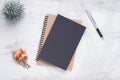 Mockup blank black book cover with pen, Christmas ornaments decor on white grunge wooden table background. Flat lay, Top view with Royalty Free Stock Photo