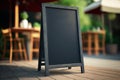 Mockup blank chalkboard menu, for restaurant, coffe shop, bar, copy space, in a terrace with blurred people in background, Royalty Free Stock Photo