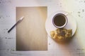 Mockup blank craft sheet of blank craft paper,pen, eye glasses and morning coffee cup with croissant on white wooden Royalty Free Stock Photo