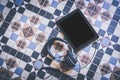 Mockup of blank electronic tablet screen conected with headphnes on Mediterranean tile floor. Empty mock-up background Royalty Free Stock Photo