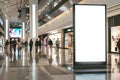 Mockup of a blank, empty billboard, facing the camera, large and busy shopping mall hall, blurred moving people Royalty Free Stock Photo