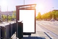 Mockup of a blank empty white advertising urban billboard, placeholder template city street, space for design layout, sunset light Royalty Free Stock Photo