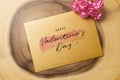 Mockup blank envelop on log wood for Valentine`s Day. Mock up for elegant design. Flat lay top view valentine`s day background