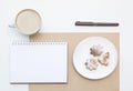 Mockup with blank notepad, cup of coffee and biscuit. New year cookies and cappuccino. Christmas morning still life. Royalty Free Stock Photo