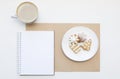 Mockup with blank notepad, cup of coffee and biscuit. New year cookies and cappuccino. Christmas morning still life. Royalty Free Stock Photo