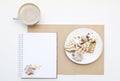 Mockup with blank notepad, cup of coffee and biscuit. New year cookies and cappuccino. Christmas morning still life. Royalty Free Stock Photo