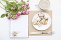 Mockup with blank notepad, cup of coffee and little garden pink roses. New year cookies and cappuccino. Christmas Royalty Free Stock Photo