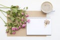 Mockup with blank notepad, cup of coffee and little garden pink roses. New year cookies and cappuccino. Christmas Royalty Free Stock Photo