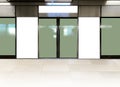Mockup of blank poster advertising space in generic train station; OOH mock up. Straight front view of MRT platform, without