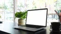 Mockup blank screen laptop on black desk and office supplies. Royalty Free Stock Photo