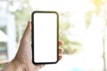 Mockup of blank screen mobile phone. Man hand holding and using a mobile phone with white blank screen. Royalty Free Stock Photo