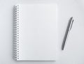 Mockup blank space on spiral notebook. White template on sketch book, vertical full page with silver pen.