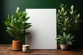 Mockup. Blank white picture frame, poster, canvas board with potted plants standing on wooden table near green wall Royalty Free Stock Photo