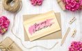 Mockup blank wooden card and envelop on grunge white wood with kraft paper roses and hand made craft gift box for Valentine`s Day Royalty Free Stock Photo