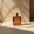 Mockup of brown square perfume bottle with golden cap on concrete surface. Shadow of tree branches on the wall. Elegant template Royalty Free Stock Photo