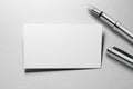 Mockup of business card with fountain pen at white paper background Royalty Free Stock Photo