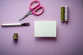 Mockup business card for sewing or textile , tailor or home made. on mauve background Royalty Free Stock Photo