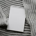 Mockup of cards at white textured watercolor paper background. Top view of spiral notebook Abstract knitting fabric