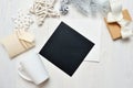 Mockup Christmas black greeting card letter in envelope and mug, flatlay on a white wooden background, with place for Royalty Free Stock Photo