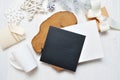 Mockup Christmas black greeting card letter in envelope and mug, flatlay on a white wooden background, with place for Royalty Free Stock Photo