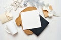 Mockup Christmas black greeting card letter in envelope and mug, flatlay on a white wooden background, with place for Royalty Free Stock Photo