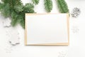 Mockup Christmas greeting card with envelope on wooden white background with fir tree branches and happy new year Royalty Free Stock Photo