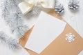 Mockup Christmas greeting card letter in envelope with white tree and cone, flatlay on a wooden background, with place Royalty Free Stock Photo