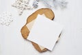 Mockup Christmas greeting card letter in envelope with white tree, flatlay on a white wooden background, with place for Royalty Free Stock Photo