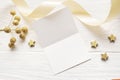 Mockup Christmas greeting card top view and gold star, flatlay on a white wooden background with a ribbon, with place Royalty Free Stock Photo